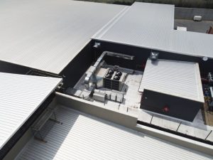 Aerial view of Shoprite Plant Area showing packaged rooftop unit with supply and return double skin ducting, economizer bank, smoke extract fans and portion of refrigeration plant area