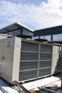 Custom-designed Shoprite packaged rooftop unit manufactured in Malaysia pictured with LG VRF condenser serving liquor store ducted hide away.
